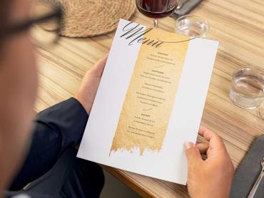 Mann hält Menükarte auf SIGEL Motiv-Papier in der Hand