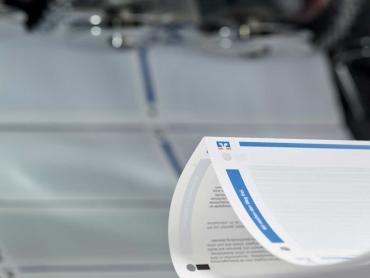 Fertiges Druckprodukt kommt aus Druckmaschine