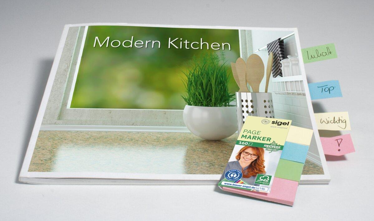 Modern Kitchen cookbook with plant motif, marked with colorful sticky notes
