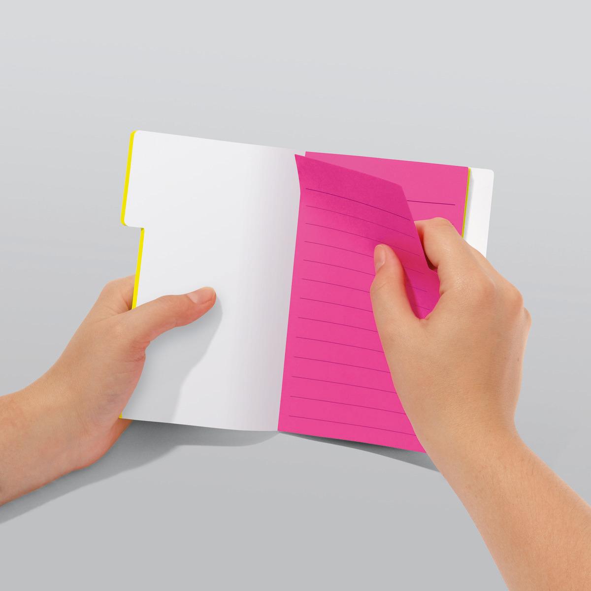 Notebook with white and pink pages Two hands turn a page