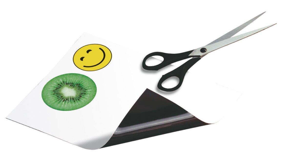 White side with smiley and kiwi, next to black scissors