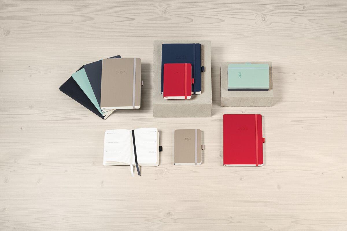 Planer in verschiedenen Farben auf hellem Tisch arrangiert