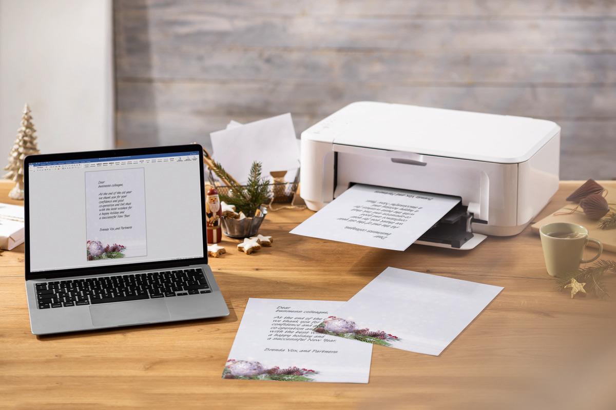 Laptop and printer on table, printed letter