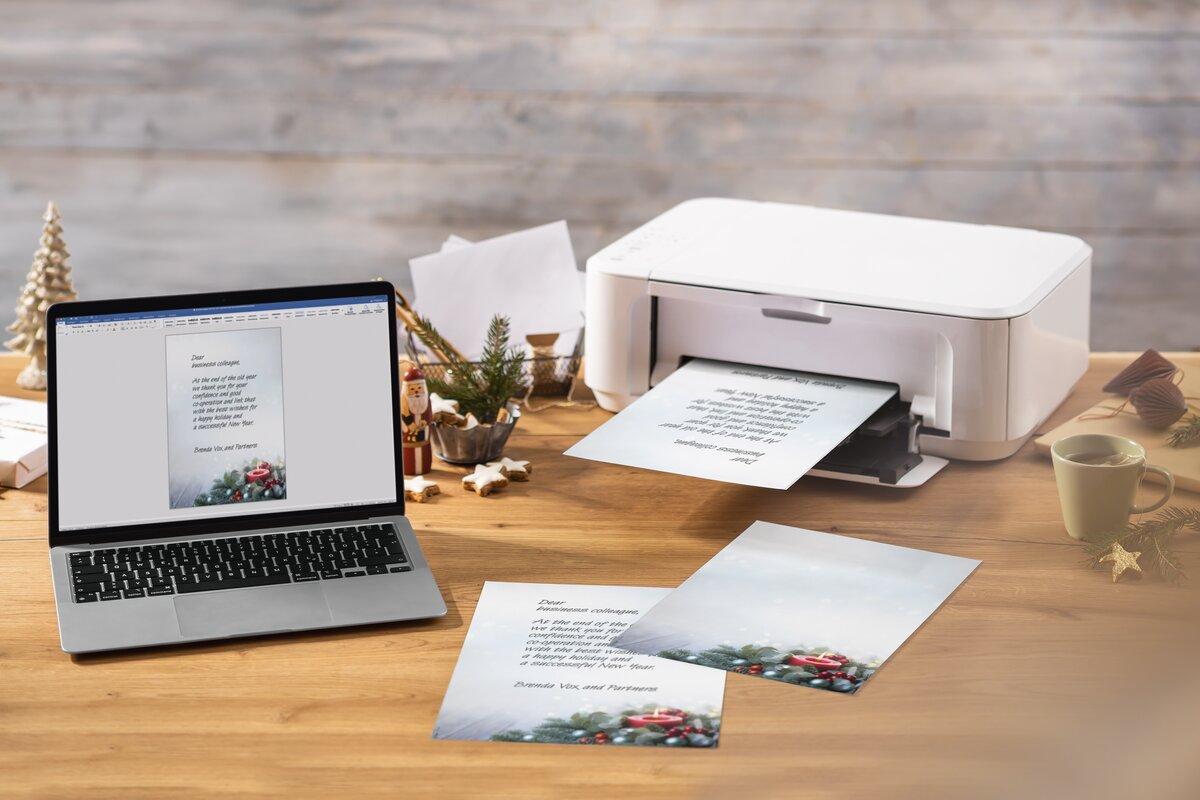 Laptop and printer on wooden table