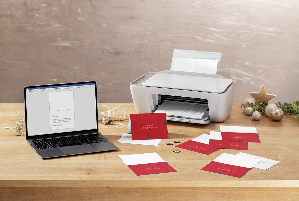 Laptop and printer on table, Christmas cards