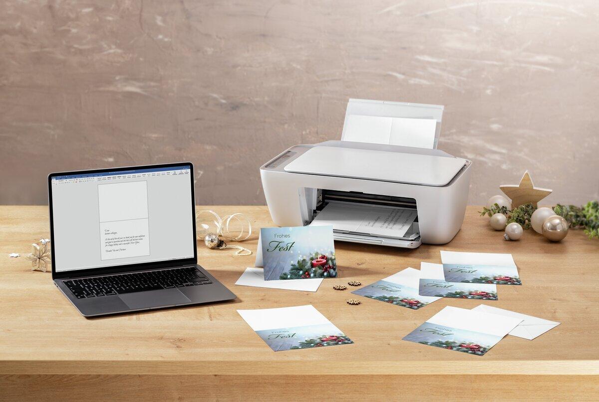 Laptop and printer on table, Christmas cards