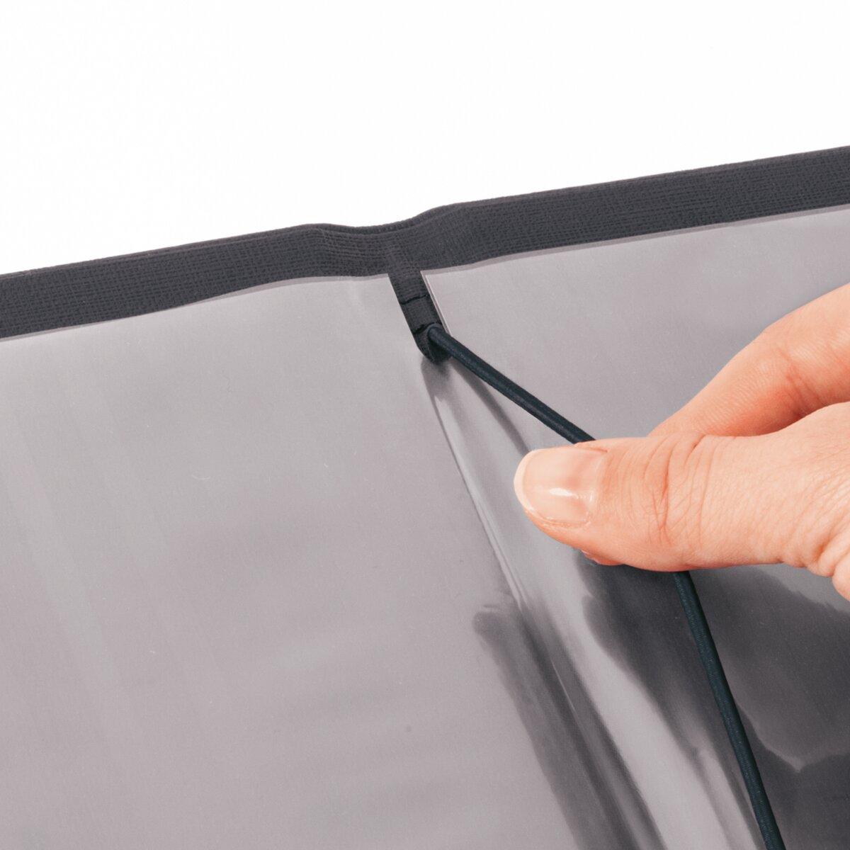 Hand pulls black rubber through transparent sleeve