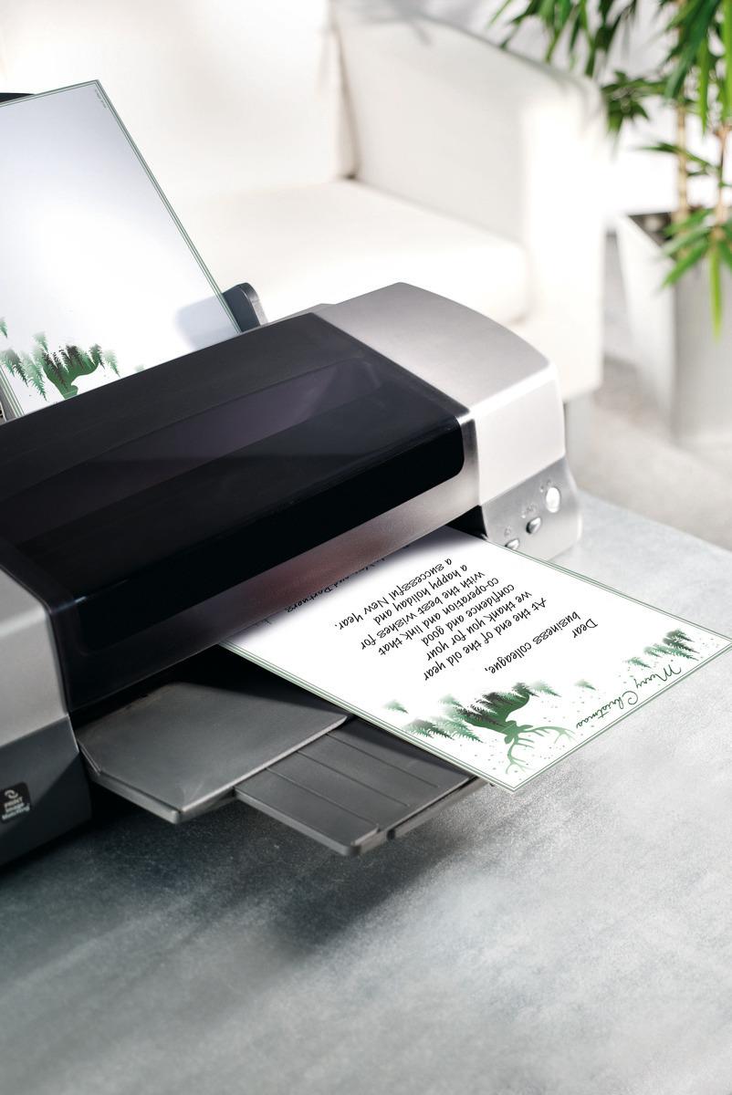 Printer on table with printed paper In the background plant and sofa