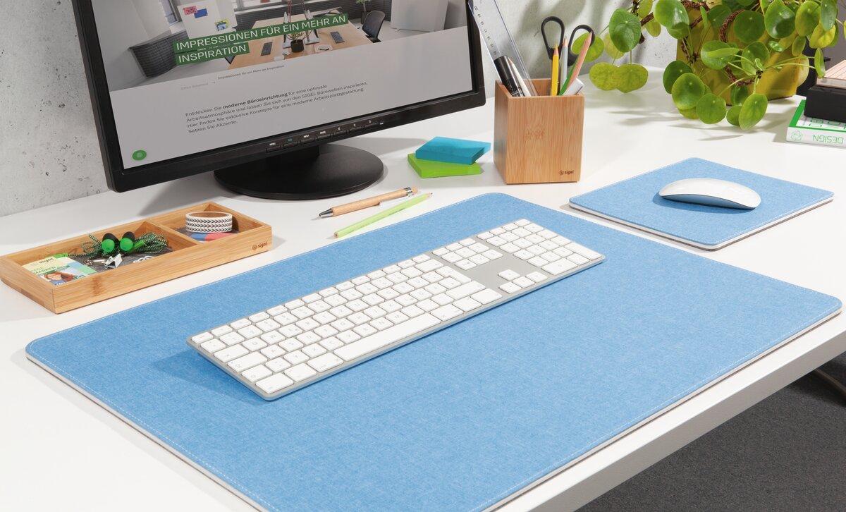 Computer desk with monitor, keyboard, mouse and plants