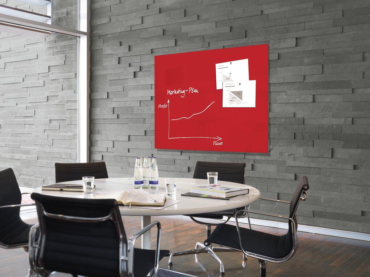 conference table with chairs; red whiteboard with diagram on the wall