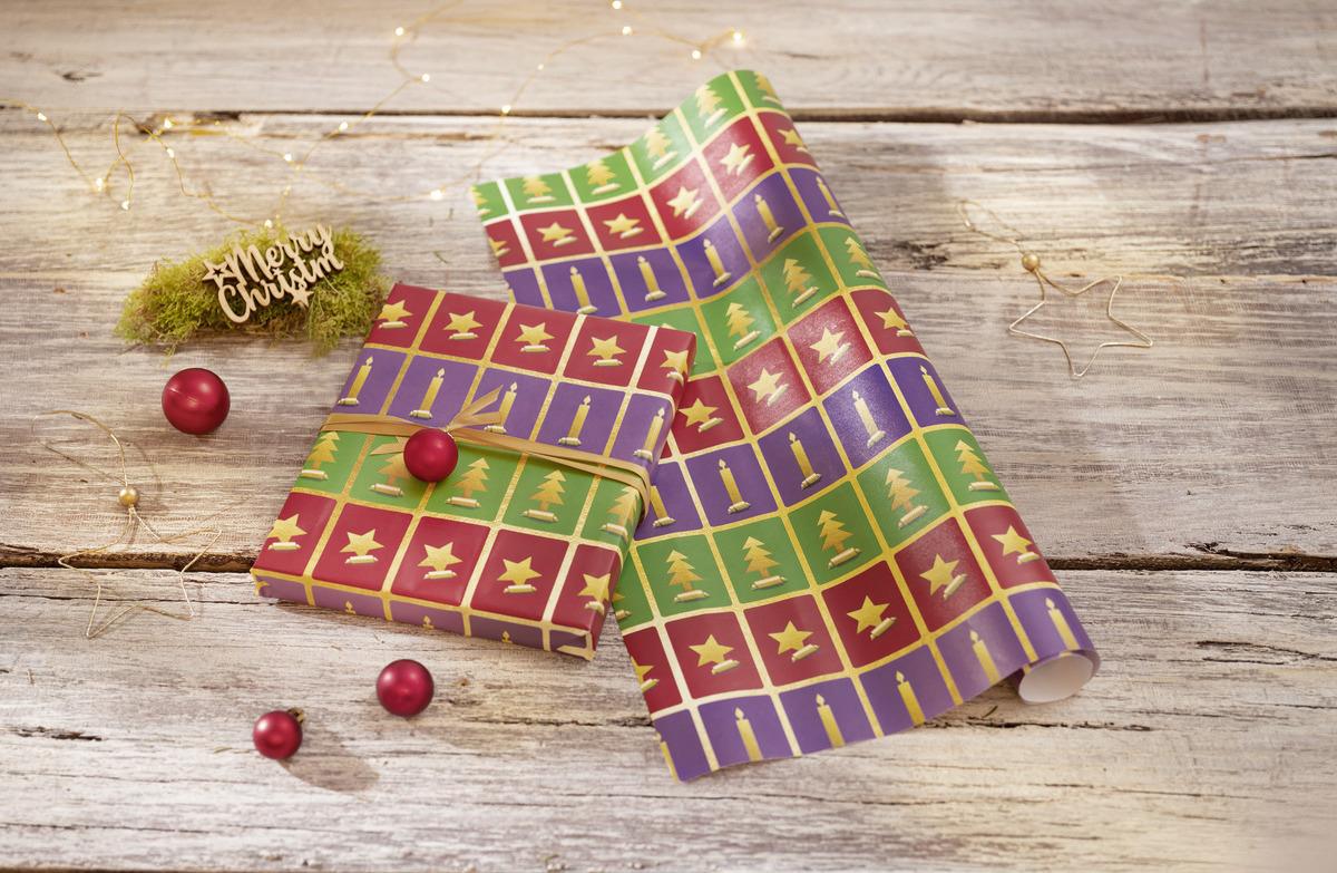 Wrapping paper with Christmas motifs, gift with red ball on it