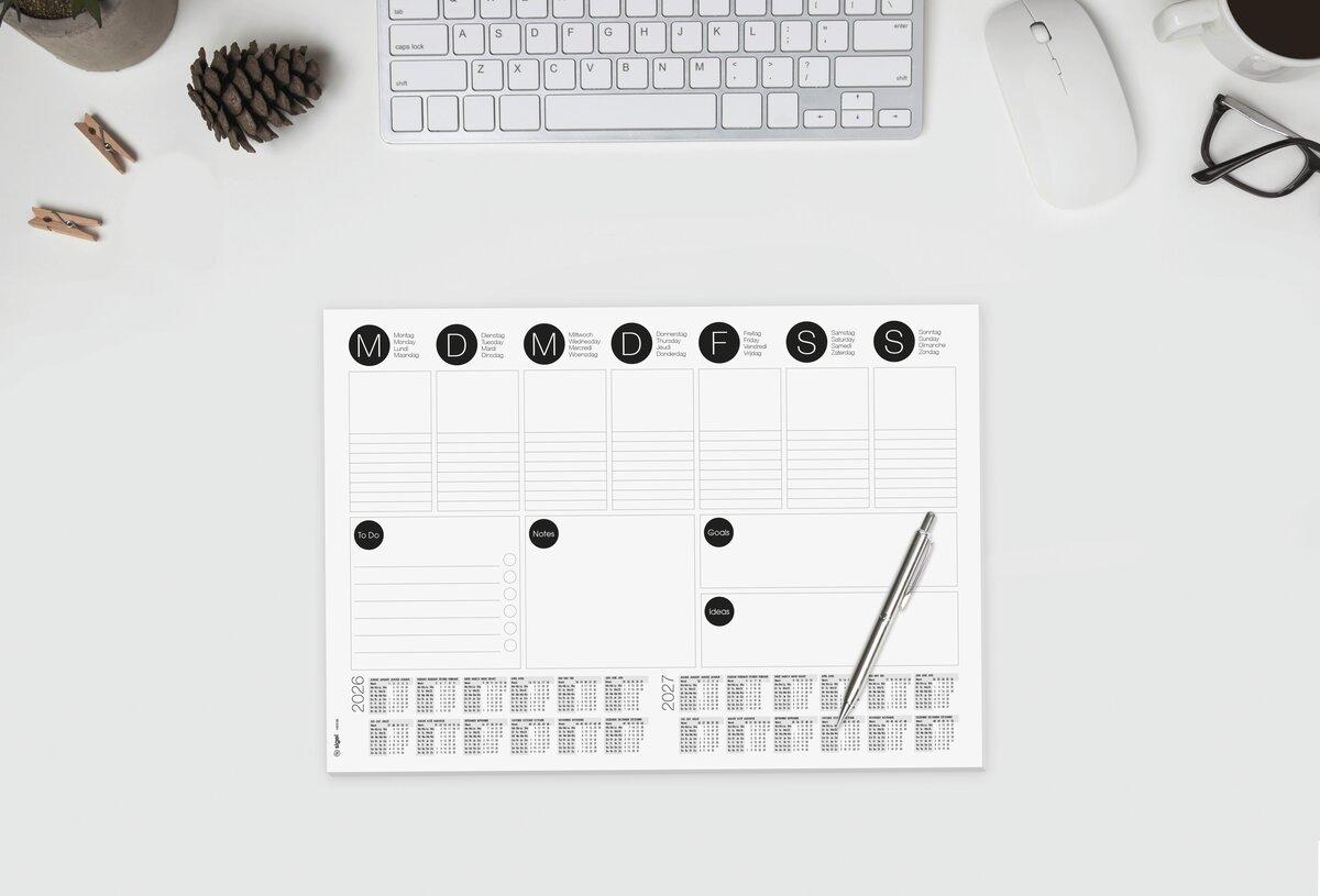 Desk with keyboard, calendar pad and pen
