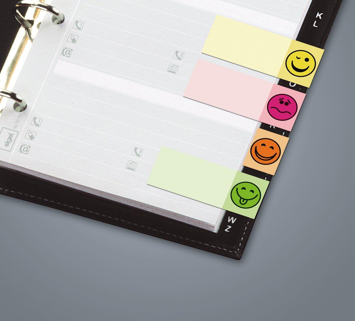 Ring binder with colored tabs, each with a smiley face