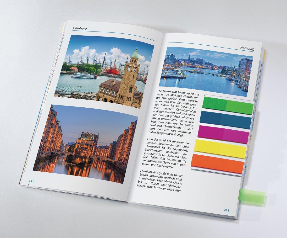 Open book with photos and text about Hamburg Colour-coded sticky notes on the right side