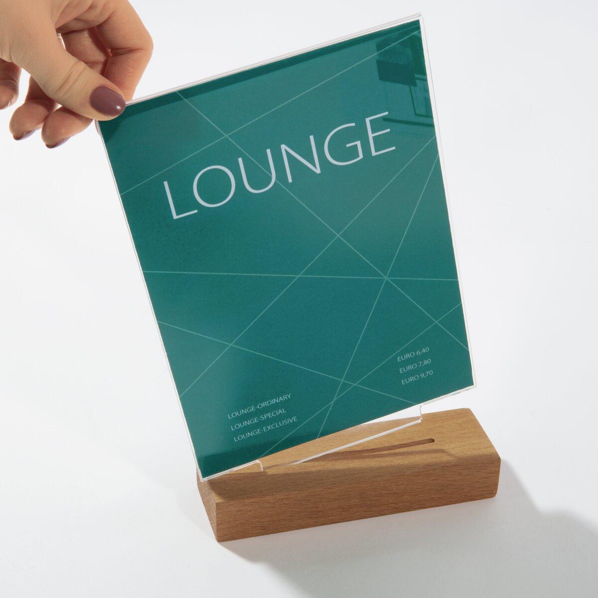 Blue lettering LOUNGE on green background stuck in wooden stand