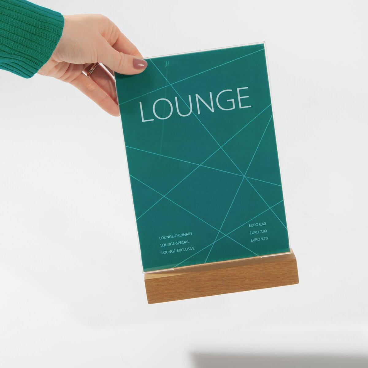 Blue stand with LOUNGE and price list is held by one hand, wooden base underneath