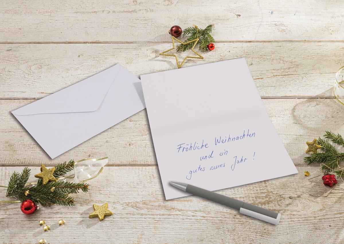 Christmas card with lettering surrounded by fir branches and decoration