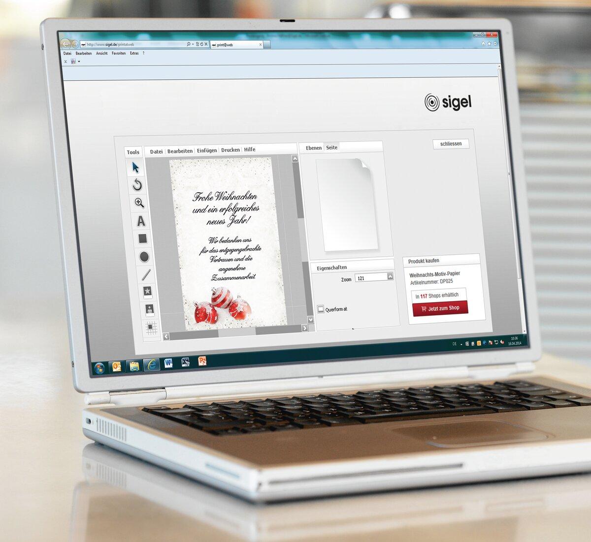 Laptop shows Christmas card preview in design software