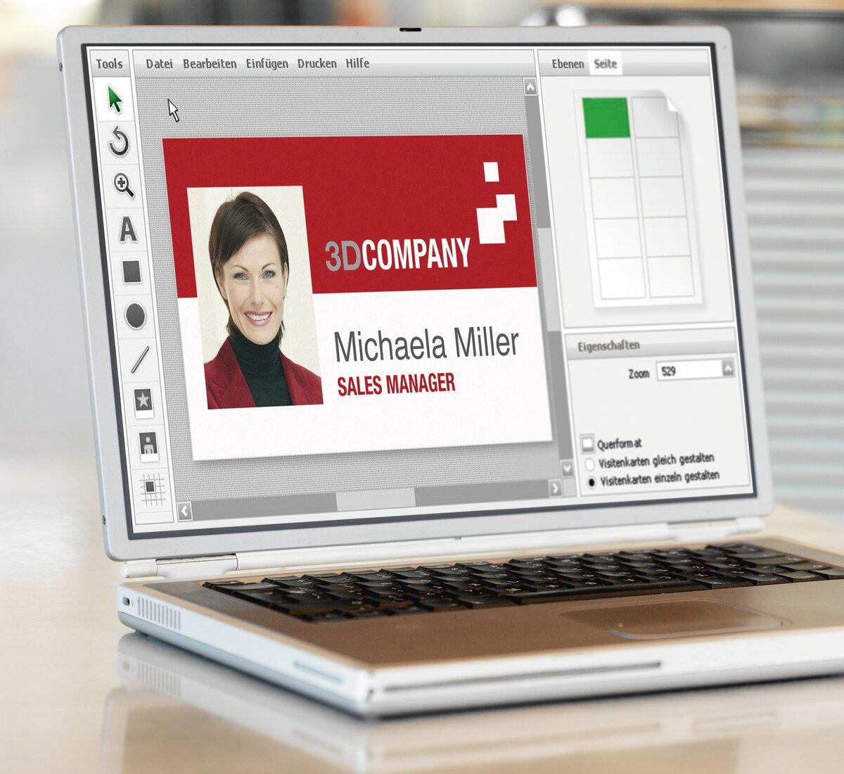 Laptop with open business card software, portrait of a woman on it and text Michaela Miller, Sales Manager