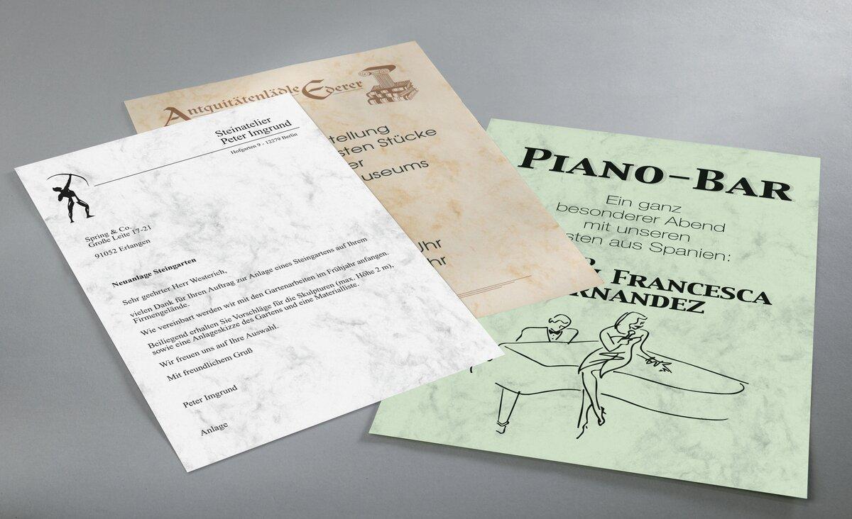 Three different flyers on grey table