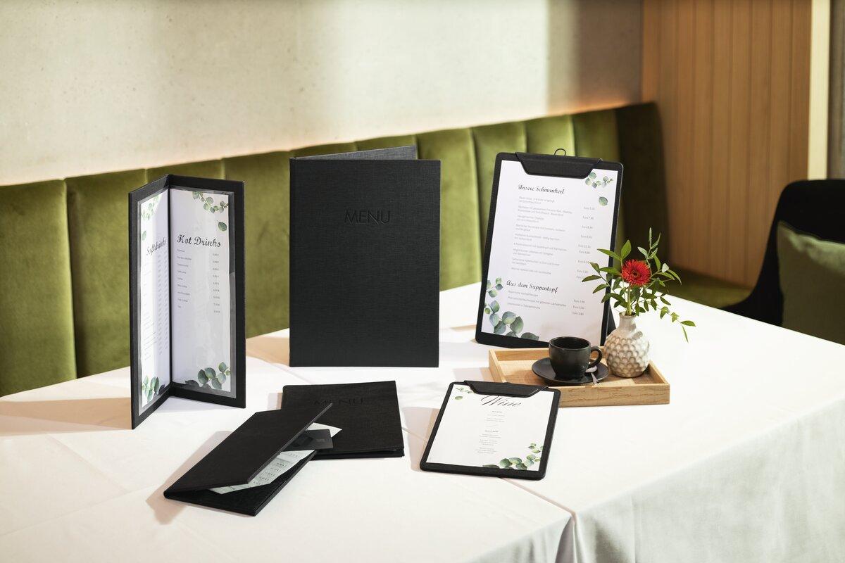 Menus and vase on table