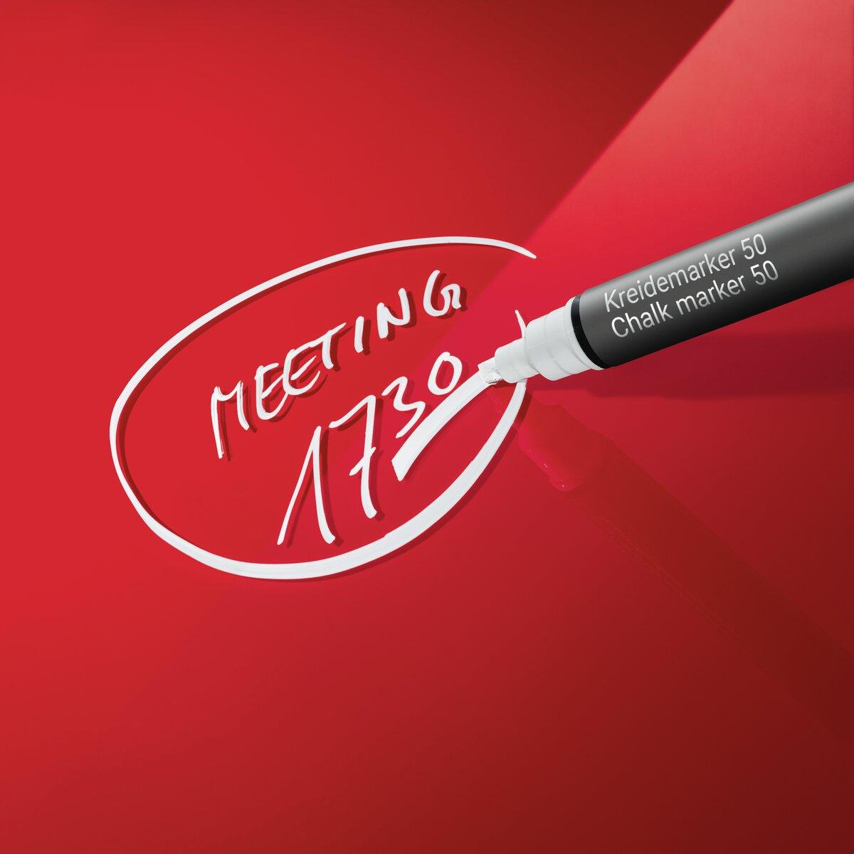 Chalk marker writing meeting 17:30 on red background