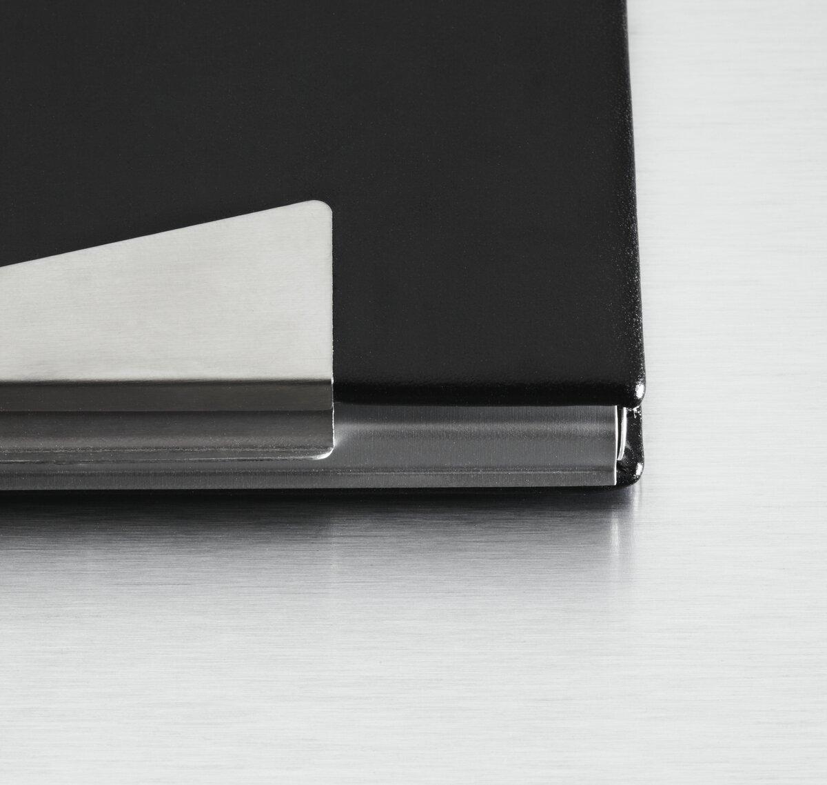 Black laptop corner detail on silver background