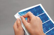 Hands peel off blue sticker