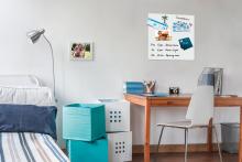 Bed and desk in bedroom Note board with appointments on the wall