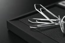 Paper clips on black tray