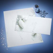 White cards with pine cone motif, blue Christmas balls on blue background