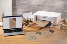Laptop and printer on wooden table