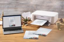 Laptop and printer on wooden table