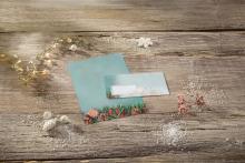 Christmas card on wooden table with decoration