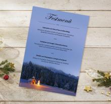 Festive menu card on wooden table, decorated with fir branch and stars