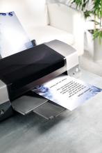 Printer on table with printed paper