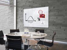 Conference room with table, chairs and whiteboard labeled on the wall
