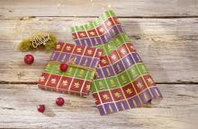 Wrapping paper with Christmas motifs, gift with red ball on it