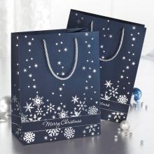 Blue gift bags with snowflakes and Merry Christmas lettering