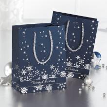 Blue gift bags with snowflakes environment with baubles and stars