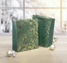 Two gift bags with golden ornaments surrounded by Christmas tree baubles