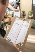Menu with drink prices, person looks at it