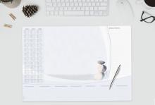 Desk pad with calendar, note field, pen and pebbles