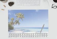 Tropical beach calendar on desk keyboard, glasses and cup of coffee