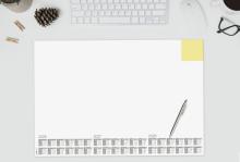 Desk with keyboard, calendar and pen Top left pine cones and coffee cup