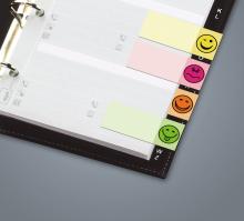 Ring binder with colored tabs, each with a smiley face