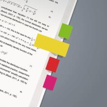 Page with mathematical formulas, four colorful sticky notes