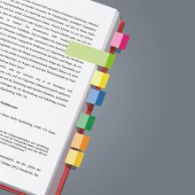 Open book with colorful markers in the margin