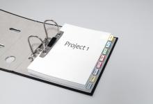 Open folder with Project 1 cover page and tabs 1 through 8