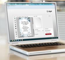 Laptop showing Christmas card on graphics software